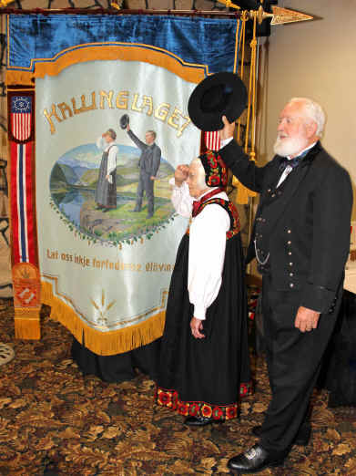 Picture of man next to banner with same clothes.